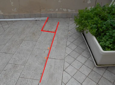 Pavimentazione del terrazzo accanto a una fioriera, con il percorso seguito segnato in rosso.